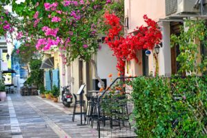 Old houses in the narrow streets of Nafplion town with Bougainvillea flowers